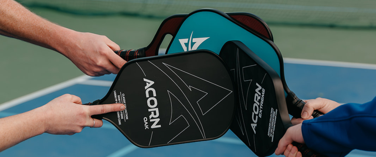 A group of Acorn Pickleball paddles cheersing in a circle