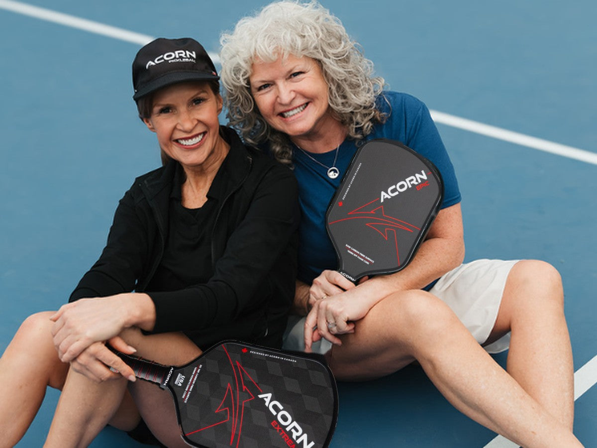 Two players smiling on court with the Acorn Extreme and Epic paddles